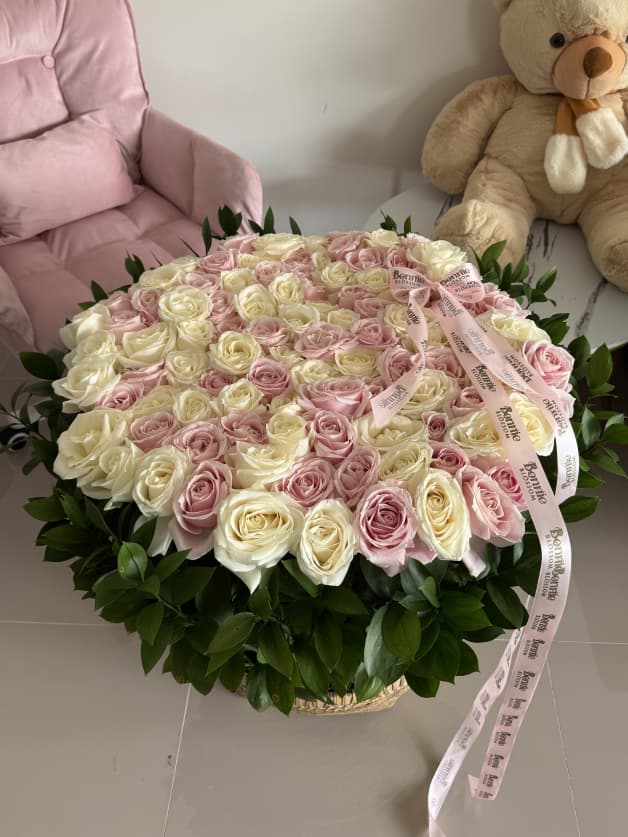 A magnificent basket arrangement of 101 pink and white Holland roses
